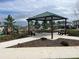 Community pavilion with bench seating on a concrete pad, offering shaded comfort for residents at 2273 Lost Horizon Way, Clermont, FL 34715