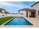 Backyard view featuring a sparkling pool, lush landscaping, and stylish lounge chairs at 2273 Lost Horizon Way, Clermont, FL 34715