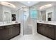 Well-lit bathroom with double vanity, glass-enclosed shower, and modern fixtures at 2348 Clemblue Rd, Clermont, FL 34715