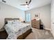 Well-lit bedroom with neutral tones, ceiling fan, and functional furniture providing a serene atmosphere at 2348 Clemblue Rd, Clermont, FL 34715