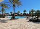 Community pool featuring cabanas, lounge chairs, and palm trees at 2348 Clemblue Rd, Clermont, FL 34715