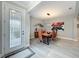 Dining room with a modern light fixture, artistic accents, and a decorative front door at 2348 Clemblue Rd, Clermont, FL 34715