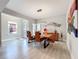 Bright dining room featuring modern decor, a wood table and unique artwork at 2348 Clemblue Rd, Clermont, FL 34715