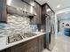 Close up view of kitchen featuring gas range, stainless steel hood, stainless steel refrigerator, and mosaic backsplash at 2348 Clemblue Rd, Clermont, FL 34715