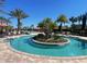 Community lazy river featuring tropical landscaping and palm trees under a clear blue sky at 2348 Clemblue Rd, Clermont, FL 34715