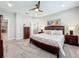 Cozy main bedroom boasts a ceiling fan, neutral tones, and an en-suite bathroom at 2348 Clemblue Rd, Clermont, FL 34715