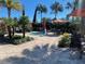 Relaxing outdoor pool area with lush landscaping and seating under the umbrellas at 2348 Clemblue Rd, Clermont, FL 34715