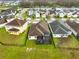 Aerial view of home with screened-in patio, fenced yard, and lake view at 2930 Wordsmith Rd, Kissimmee, FL 34746