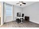 Bedroom with wood flooring, ceiling fan, natural light, desk, and chair at 2930 Wordsmith Rd, Kissimmee, FL 34746