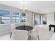 Bright dining area with water views, modern chandelier, and sliding glass doors to outdoor patio at 2930 Wordsmith Rd, Kissimmee, FL 34746