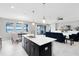 Modern kitchen with black cabinets, white countertops, and a center island with bar seating at 2930 Wordsmith Rd, Kissimmee, FL 34746