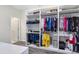 Organized walk-in closet with custom shelving and storage for clothing and accessories at 2930 Wordsmith Rd, Kissimmee, FL 34746