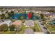 Aerial view of a home with pond view and manicured lawn in a suburban neighborhood at 3000 Stonington Run, Kissimmee, FL 34746