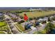 Aerial view of the home and manicured lawn in a suburban neighborhood at 3000 Stonington Run, Kissimmee, FL 34746