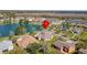 Aerial view of a home in a suburban neighborhood with pond at 3000 Stonington Run, Kissimmee, FL 34746