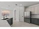 A modern kitchen featuring stainless steel appliances, gray cabinets, and stylish countertops at 3000 Stonington Run, Kissimmee, FL 34746