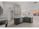 A well-lit kitchen showcasing modern appliances, gray lower cabinets and an open-concept design at 3000 Stonington Run, Kissimmee, FL 34746