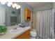 Well-lit bathroom features a large mirror, vanity storage, and shower-tub combo at 30113 Robin Ln, Tavares, FL 32778