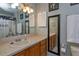 Well-lit bathroom featuring wood cabinets, a neutral countertop, and decorative art, providing a charming space at 30113 Robin Ln, Tavares, FL 32778