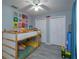 Bright bedroom with bunkbeds, light wood floors, ample closet space, and playful decor, creating an inviting space at 30113 Robin Ln, Tavares, FL 32778