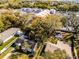 Real estate aerial view showcasing the property’s layout within the neighborhood, surrounded by mature trees at 303 S Forest Ave, Orlando, FL 32803