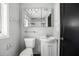 Neutral toned bathroom featuring vanity, toilet, window for natural light, and medicine cabinet above the sink at 303 S Forest Ave, Orlando, FL 32803