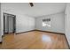 Bright living room with hardwood flooring, white walls and trim, and a window with natural light at 303 S Forest Ave, Orlando, FL 32803