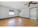 Spacious living room featuring beautiful hardwood floors, neutral paint, and ample natural light from windows at 303 S Forest Ave, Orlando, FL 32803