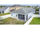 Backyard view of a house with a screened-in porch and a white picket fence at 3088 Prelude Ln, Kissimmee, FL 34746