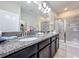 Bathroom showcasing a double vanity with granite countertops and a glass-enclosed shower at 3088 Prelude Ln, Kissimmee, FL 34746