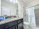 Modern bathroom featuring granite counters, a large mirror, and glass-enclosed shower at 3088 Prelude Ln, Kissimmee, FL 34746