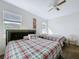 Bright bedroom featuring two beds and a ceiling fan at 3088 Prelude Ln, Kissimmee, FL 34746