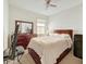 Bedroom featuring a wooden bed frame, dresser with mirror, and a ceiling fan at 3088 Prelude Ln, Kissimmee, FL 34746