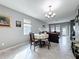 Open dining area with a round table, chandelier, and seamless connection to the living room at 3088 Prelude Ln, Kissimmee, FL 34746