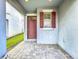 Cozy front porch with a stylishly colored front door and adjacent window with matching shutters at 3088 Prelude Ln, Kissimmee, FL 34746