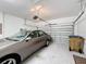 Spacious garage with a car parked inside, and an automatic door at 3088 Prelude Ln, Kissimmee, FL 34746