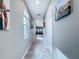 Bright hallway features tile floors, neutral walls, and an array of artwork creating an inviting atmosphere at 3088 Prelude Ln, Kissimmee, FL 34746