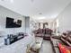 Bright living room with gray walls, tile flooring and open floor plan leading into kitchen at 3088 Prelude Ln, Kissimmee, FL 34746