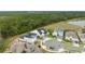 Aerial view of several homes in a suburban neighborhood with a pond in the distance at 3135 Vanguard Ct, St Cloud, FL 34771