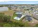 Aerial view of a home with a backyard pool, metal fence and view of a pond at 3135 Vanguard Ct, St Cloud, FL 34771