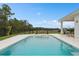 Expansive backyard with a pool, spa, and covered patio creating the perfect setting for relaxation and gatherings at 3135 Vanguard Ct, St Cloud, FL 34771