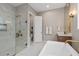 Light-filled bathroom with a walk-in shower, freestanding tub, and modern fixtures at 3135 Vanguard Ct, St Cloud, FL 34771