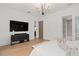 Modern bedroom with a mounted TV, connecting bathroom, and neutral color palette at 3135 Vanguard Ct, St Cloud, FL 34771