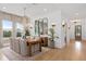 Bright dining room with wood floors, natural light, a wood dining table, and modern decorative elements at 3135 Vanguard Ct, St Cloud, FL 34771