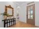 Stylish entryway featuring a decorative mirror, console table, and view into the bedroom at 3135 Vanguard Ct, St Cloud, FL 34771