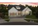 Beautiful modern farmhouse with a three-car garage and covered porch on a landscaped lawn at 3135 Vanguard Ct, St Cloud, FL 34771