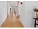 Bright hallway featuring hardwood floors and views into the living room area at 3135 Vanguard Ct, St Cloud, FL 34771