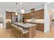 Lovely kitchen island featuring a quartz countertop, stainless steel appliances, and wood cabinets at 3135 Vanguard Ct, St Cloud, FL 34771