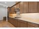 Kitchen featuring under-cabinet lighting, quartz countertops, and wood cabinetry at 3135 Vanguard Ct, St Cloud, FL 34771