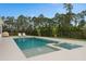 Backyard pool with a jacuzzi and lounge chairs on the concrete deck surrounded by a black metal fence at 3135 Vanguard Ct, St Cloud, FL 34771